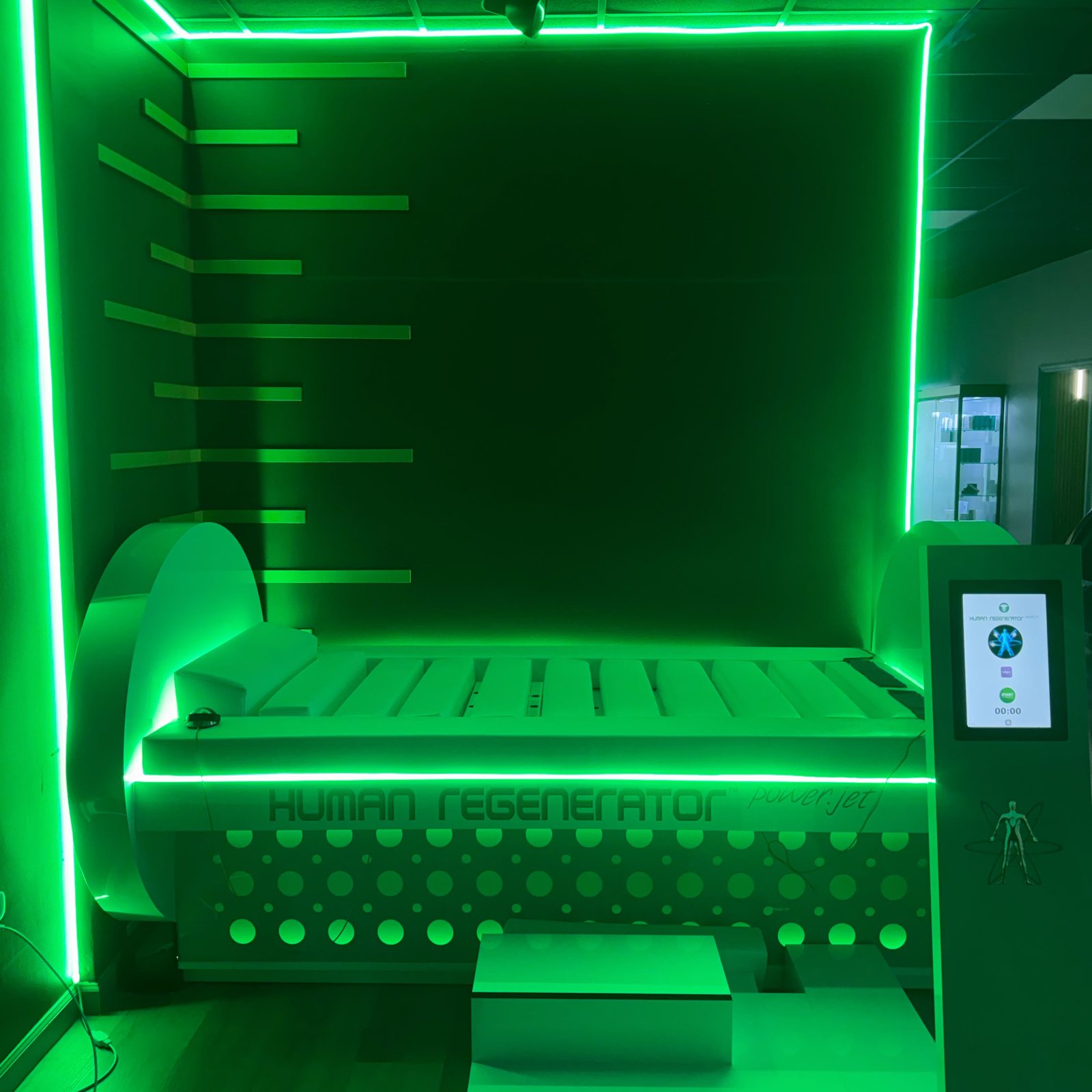 The Human Regenerator in its treatment alcove at Vytara, the room outlined in green light