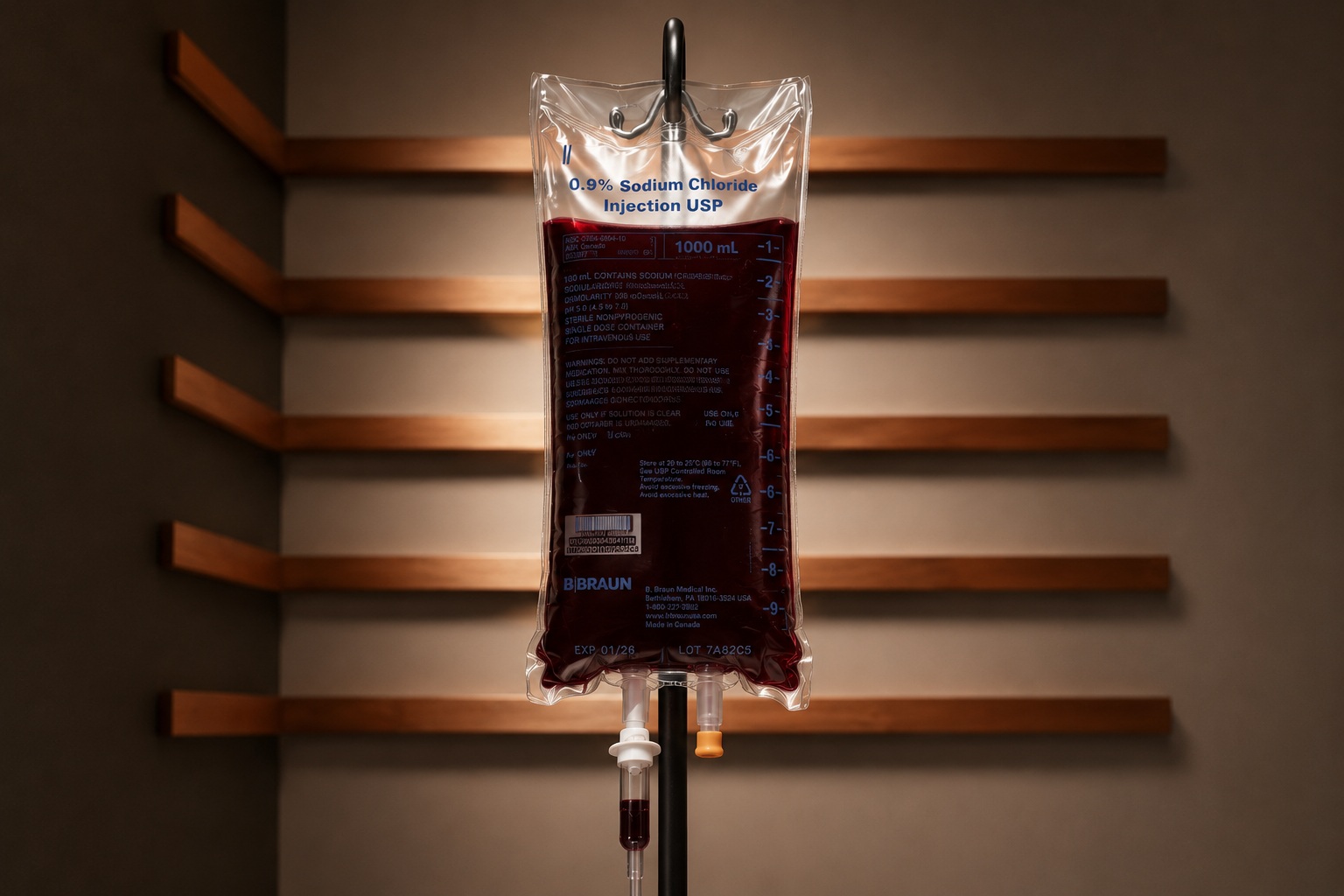 A bag of the guest's own ozonated blood on an IV stand against warm wood at Vytara