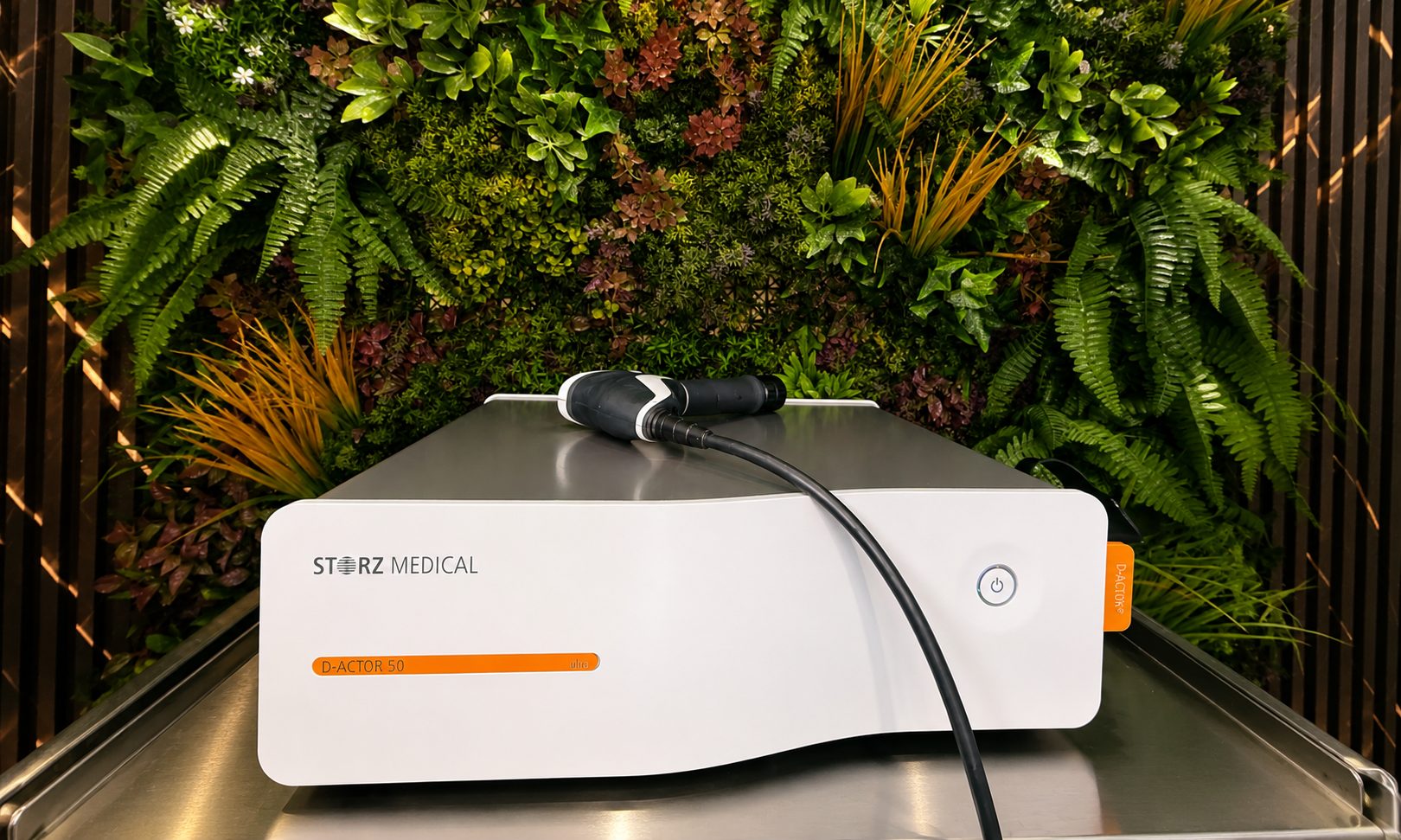 The Storz Medical D-ACTOR 50 shockwave device against a living moss wall at Vytara