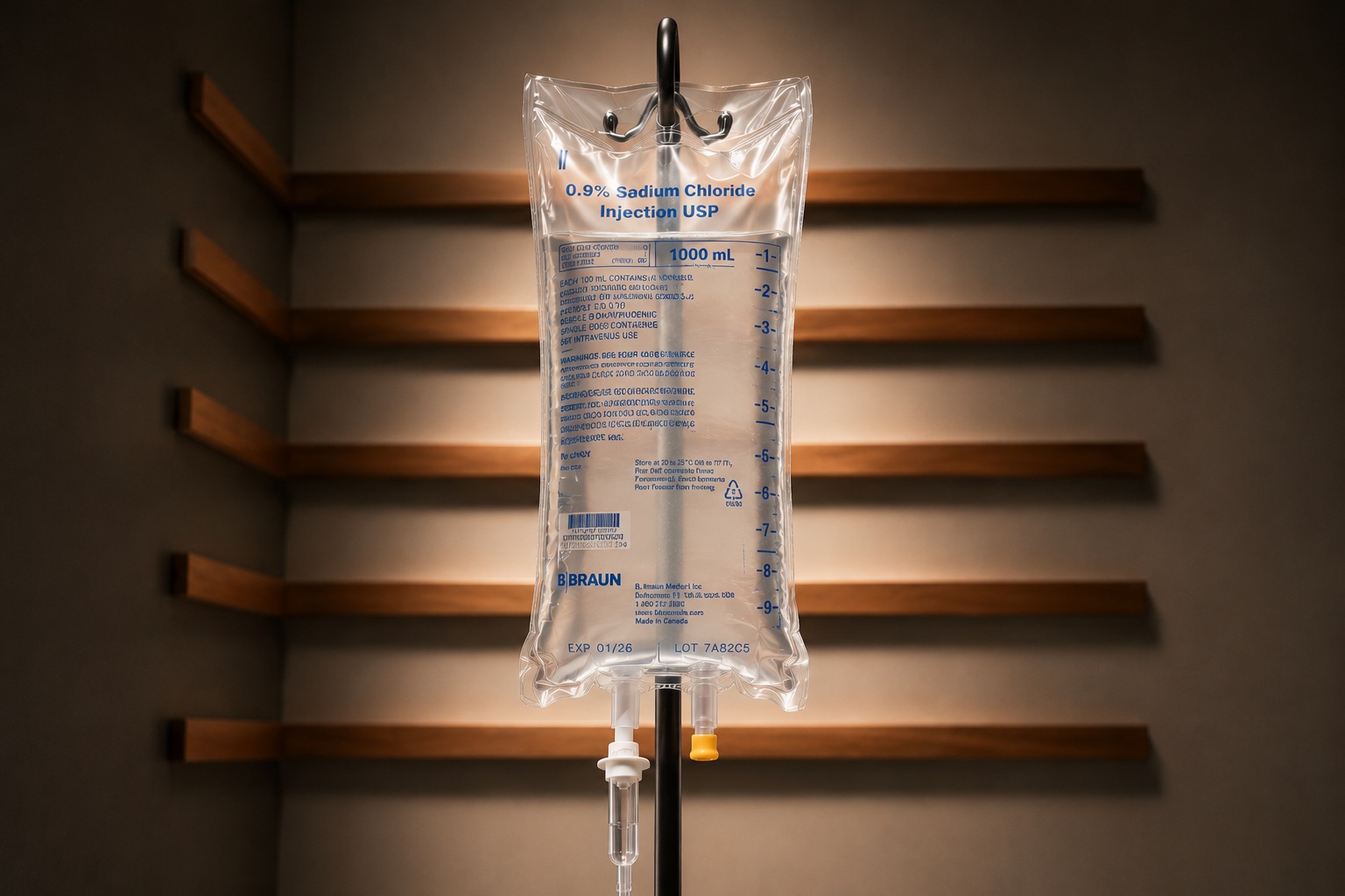 A clear IV bag of stem cell infusion on an IV stand against warm wood at Vytara